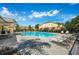 Community pool with lounge chairs and covered patio at 4235 Winding Vine Dr # 148, Lakeland, FL 33812