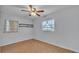 Simple bedroom with wood-look flooring, ceiling fan, and window coverings at 470 Lucille St, Bartow, FL 33830