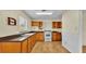 Galley style kitchen with wood cabinets and white appliances at 470 Lucille St, Bartow, FL 33830