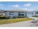 Single story house with a white exterior, garage and well-maintained lawn at 4854 Colonnades Club Blvd, Lakeland, FL 33811