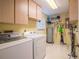 Bright laundry room, washer, dryer, and storage cabinets at 4854 Colonnades Club Blvd, Lakeland, FL 33811