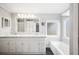 Bathroom with double vanity, marble countertop, and bathtub at 4938 Deerwood Dr, Lakeland, FL 33810