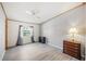 Bedroom featuring neutral colors, updated flooring, a ceiling fan and a window with a view at 4938 Deerwood Dr, Lakeland, FL 33810