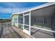 Screened porch with pet door and access to porch with outdoor furniture and stairs at 4938 Deerwood Dr, Lakeland, FL 33810