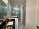 Bathroom with dark granite countertops, gray cabinets and a glass shower at 516 Homecoming Way, Polk City, FL 33868