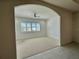 Spacious bedroom with window, ceiling fan, and arched entryway at 516 Homecoming Way, Polk City, FL 33868