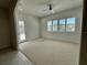 Bright bedroom with carpeted floor, large windows, and door to outside at 516 Homecoming Way, Polk City, FL 33868