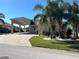 Home exterior with covered entryway and tropical landscaping at 516 Homecoming Way, Polk City, FL 33868