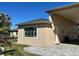 Exterior of tan home featuring paved driveway and manicured lawn at 516 Homecoming Way, Polk City, FL 33868