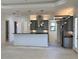 Modern kitchen with gray cabinets, stainless steel appliances, and an island at 516 Homecoming Way, Polk City, FL 33868