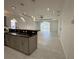 Open concept kitchen with island, pendant lighting, and gray cabinets at 516 Homecoming Way, Polk City, FL 33868