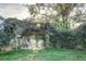 Secluded backyard patio with leafy arbor and seating area at 518 Boger N Blvd, Lakeland, FL 33803