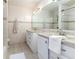 Shared bathroom with double vanity and beige tile at 518 Boger N Blvd, Lakeland, FL 33803