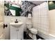 Stylish bathroom with hexagon tile floor, and tropical wallpaper at 518 Boger N Blvd, Lakeland, FL 33803