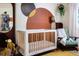 Charming Bedroom features a crib, rocker, and custom wall mural at 518 Boger N Blvd, Lakeland, FL 33803