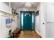 Bright entryway with teal door, wood floors, and bench at 518 Boger N Blvd, Lakeland, FL 33803