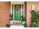 Green front door with wreath, flanked by potted plants at 518 Boger N Blvd, Lakeland, FL 33803