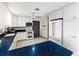 Modern kitchen with white cabinets, blue countertops and stainless steel appliances at 518 Boger N Blvd, Lakeland, FL 33803