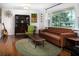 Mid century modern living room with brown leather couch at 518 Boger N Blvd, Lakeland, FL 33803