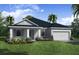 Single-story home with gray exterior, dark roof, and landscaping at 5451 Duxford Cir, St Cloud, FL 34771