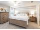 Main bedroom with a wood bed frame, neutral color palette, and ample natural light at 5544 Maddie Dr, Haines City, FL 33844