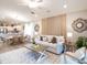 Living room featuring a neutral color palette, a wood-look wall, and comfortable seating at 5544 Maddie Dr, Haines City, FL 33844