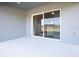 Light grey patio with sliding glass door leading to interior at 5544 Maddie Dr, Haines City, FL 33844