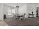 Bright dining room with six-chair table, modern chandelier, and carpet flooring at 6046 Eagle Pointe Dr, Lakeland, FL 33812