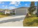 One-story home with gray exterior, two-car garage, and well-manicured lawn at 6046 Eagle Pointe Dr, Lakeland, FL 33812