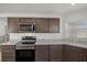 Kitchen with stainless steel appliances and dark brown cabinets at 6046 Eagle Pointe Dr, Lakeland, FL 33812