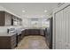 Modern kitchen with dark brown cabinets, stainless steel appliances, and tile floor at 6046 Eagle Pointe Dr, Lakeland, FL 33812