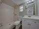 Bathroom with white vanity, shower and tile at 702 Nw 1St Ave, Mulberry, FL 33860