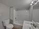 Updated bathroom with a tub, sink and linen cabinet at 702 Nw 1St Ave, Mulberry, FL 33860