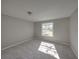 Bright bedroom with a window and carpet flooring at 702 Nw 1St Ave, Mulberry, FL 33860