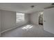 Bright bedroom with window, neutral carpet and ensuite bath at 702 Nw 1St Ave, Mulberry, FL 33860