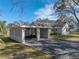 Carport with decorative block walls and a gate at 702 Nw 1St Ave, Mulberry, FL 33860