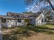 Side view of the house, highlighting its light beige siding at 702 Nw 1St Ave, Mulberry, FL 33860