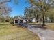 House exterior showcasing a carport and spacious yard at 702 Nw 1St Ave, Mulberry, FL 33860