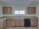 Updated kitchen featuring wood cabinets and a dishwasher at 702 Nw 1St Ave, Mulberry, FL 33860