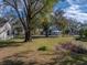 Spacious side yard with mature trees and grassy area at 702 Nw 1St Ave, Mulberry, FL 33860