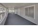 Sunroom with gray carpet and windows offering natural light at 702 Nw 1St Ave, Mulberry, FL 33860