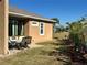 Patio area and grassy backyard with landscaping at 708 Teaberry Trl, Polk City, FL 33868