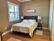 Bedroom with a queen-size bed and wood floors at 708 Teaberry Trl, Polk City, FL 33868