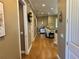 Long hallway with wood floors and access to rooms at 708 Teaberry Trl, Polk City, FL 33868