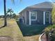 House exterior, side view, showing patio and AC unit at 708 Teaberry Trl, Polk City, FL 33868