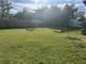 Large backyard with grassy area, playset, and wooden structure at 709 E Lowell St, Lakeland, FL 33805