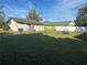 Large grassy backyard with storage shed and playset at 709 E Lowell St, Lakeland, FL 33805