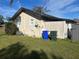 Backyard view of a house with a shed and utility area at 709 E Lowell St, Lakeland, FL 33805