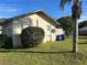 Side view of a house with a large yard and palm tree at 709 E Lowell St, Lakeland, FL 33805