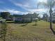 Front yard view of a single story house with a large lawn at 709 E Lowell St, Lakeland, FL 33805